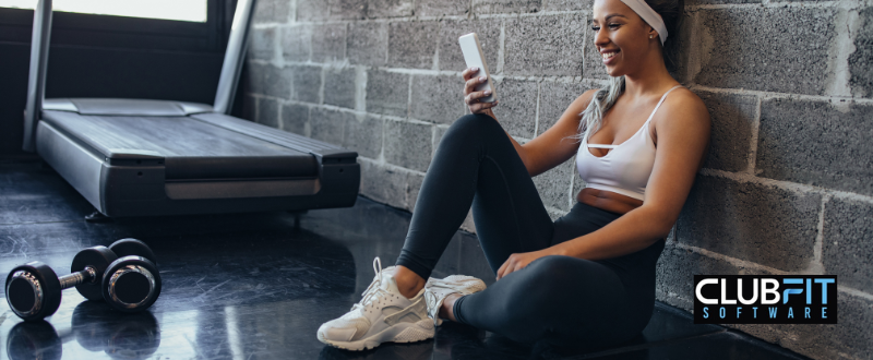 girl looking at mobile app while working out