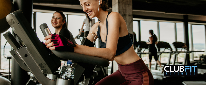 gym members training on stationary bike