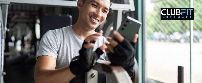 new gym member looking at mobile application new gym member looking at mobile application