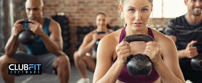 people attending a kettlebell group fitness class