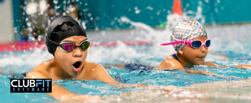 children practicing in a swim school children practicing in a swim school