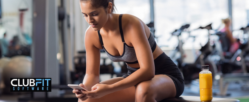 girl looking at her phone during training
