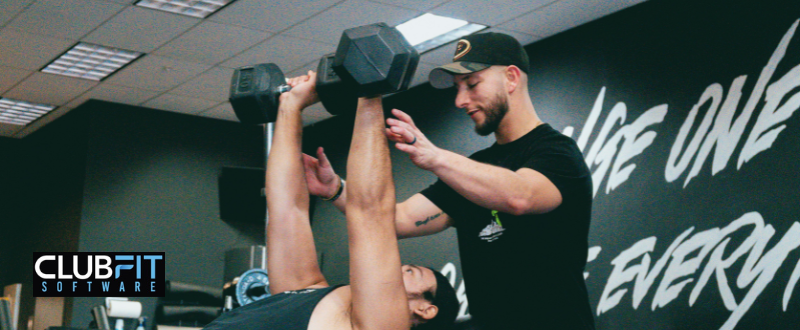 personal trainer working with client